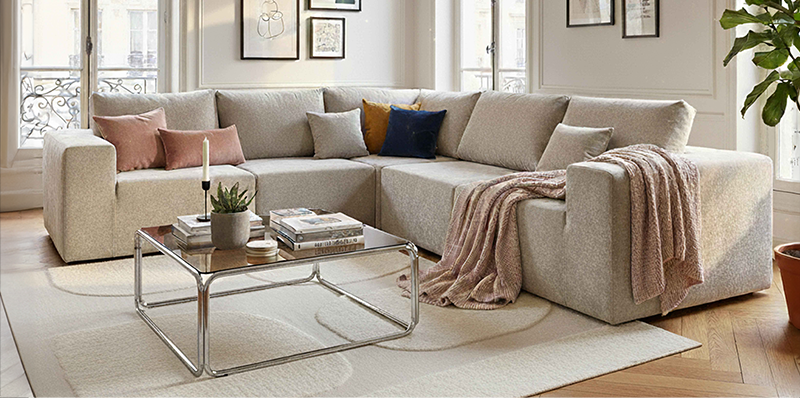 Divano modulare in tessuto con tavolo da salotto in vetro temperato